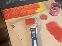 The stencil after the first layer of (red) paint.